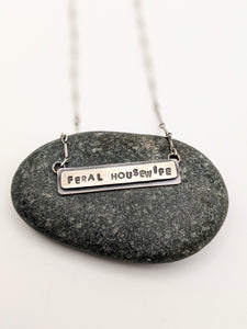 Hand stamped Sterling Silver Necklace with the words "Feral Housewife" 